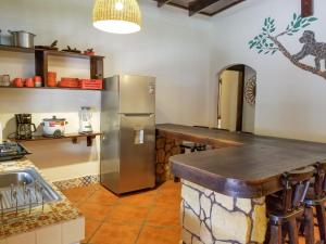 a kitchen with a stainless steel refrigerator and a counter at Macao Beach in Sámara