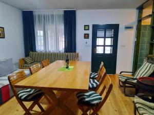 a living room with a wooden table and chairs at Vila Sava in Jarak