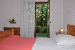 a bedroom with a bed and a sliding glass door at Apartment Peace in Rab