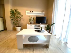einen weißen Couchtisch im Wohnzimmer mit Pflanzen in der Unterkunft Apartment Marcella 1 in Ljubač