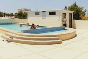 a group of people in a swimming pool at Chipipe Salinas Beachfront Apartment w Parking in Salinas