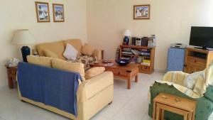 a living room with two couches and a tv at Casa Lansa in Granadilla de Abona