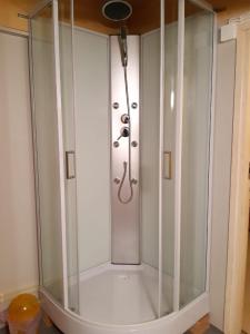 a shower with a glass enclosure in a bathroom at Yö Kotikoivun rauhassa in Kankaanpää