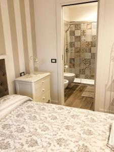 a bedroom with a bed and a bathroom with a shower at La Rosa Bianca in Rozzano +7 photos
