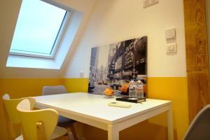 una mesa blanca en una habitación con ventana en B&B jaune, Appartement indépendant, parking, wifi près de Strasbourg, en Ittenheim