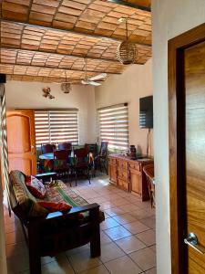 a living room with a couch and a table at Casa Balam in Rincon de Guayabitos