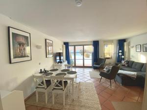 a living room with a table and a couch at Ferienwohnung Suedterrasse in Dewichow