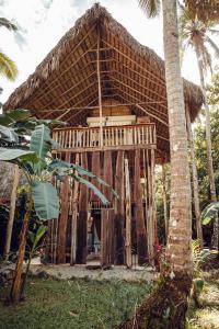 a bamboo house with a thatched roof at El Valle Lodge in El Valle