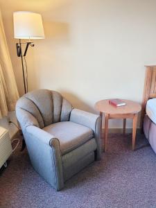 a chair and a table in a hotel room at Berlin Heritage Inn in Berlin