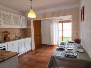 a kitchen with a table with plates and dishes on it at LEIDA - Relax y privacidad in Cala Blanca