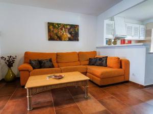 a living room with a couch and a coffee table at LEIDA - Relax y privacidad in Cala Blanca +4 photos