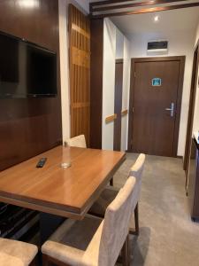 a conference room with a wooden table and chairs at Apartman LN Zlatibor in Zlatibor +5 photos