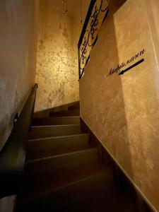 a staircase in a building with a sign on the wall at Apartmani Jović in Kuršumlija