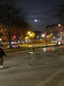 a person walking in a parking lot at night at Immeuble cours de Vincennes in Paris