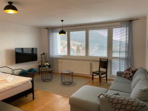 a living room with a couch and a tv at Pálava House Mikulov in Mikulov