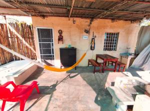 a hammock in a room with a table and chairs at CASA LILI LUXURY VALLADOLID "Fast Wifi, Hot Water, Kitchen & TV" in Valladolid