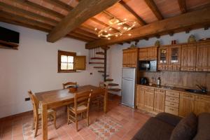 a kitchen and dining room with a wooden table at La Locanda di Giulia in Arezzo