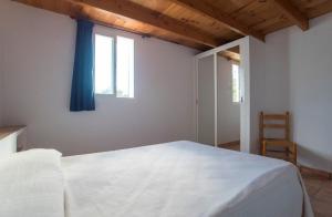 A bed or beds in a room at CASA GORKA Cala Saona