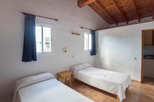 A bed or beds in a room at CASA GORKA Cala Saona