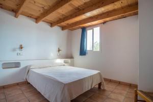 A bed or beds in a room at CASA GORKA Cala Saona