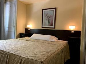 Cama ou camas em um quarto em Palace Hotel Mendoza