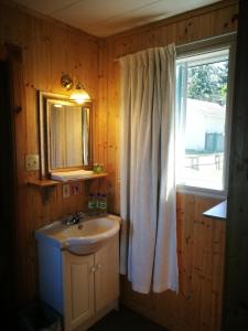 a bathroom with a sink and a window at Auberge La Coudriere (Cool Hotel) in L'Isle-aux-Coudres +112 photos