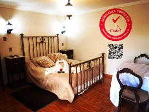 a bedroom with a crib and a sign on the wall at Hotel Español in San Fernando