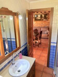 een badkamer met een wastafel en een eetkamer bij The Cliffs - Casa Crecide in O Vicedo