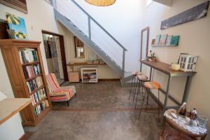 a hallway with a staircase and a living room at Nautilus B&B in Pinamar