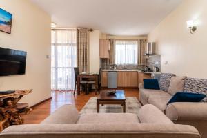 a living room with a couch and a table at Highlands Suites Hotel Apartments in Nairobi