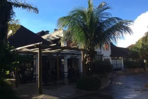 a building with a palm tree in front of it at Departamento en Condominio Buganvillas in Santa Cruz de la Sierra