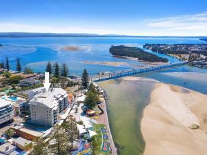 an aerial view of a beach and a bridge at The Entrance Waterfront Apartment 621 in The Entrance