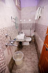 a bathroom with a sink and a toilet at Hotel Rang Sagar Haveli in Udaipur