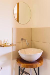 a bathroom with a bowl sink and a mirror at MANURII Garden in Utila