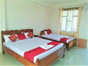 a bedroom with two beds and a window at Sulawado Resort in Cherrapunji