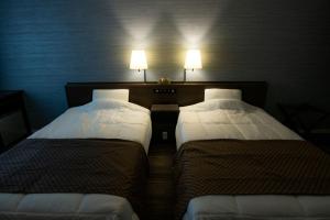 Uma cama ou camas num quarto em Sakura Shimanami Hotel