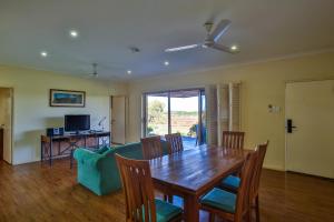 a dining room with a table and a couch at Kimberley Hotel in Halls Creek