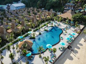 an aerial view of a resort pool with chairs and umbrellas at Phi Phi CoCo Beach Resort in Phi Phi Islands