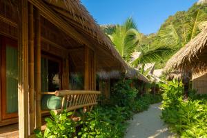 a building with a bench in front of it at Phi Phi CoCo Beach Resort in Phi Phi Islands