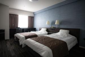 Uma cama ou camas num quarto em Sakura Shimanami Hotel