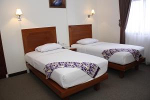 Krevet ili kreveti u jedinici u okviru objekta PIA Hotel Pangkalpinang