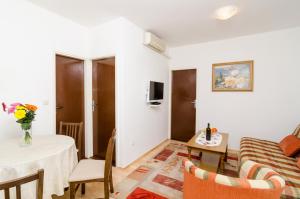 a living room with a couch and a table at Apartment Amela in Dubrovnik