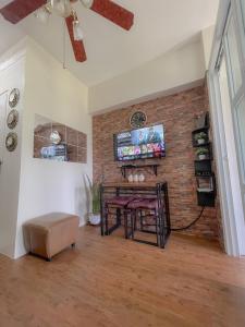 a living room with a brick wall and a table at Pearljohn's Place Tagaytay Prime Residences in Tagaytay