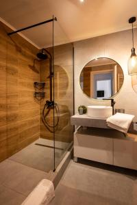une salle de bains avec un lavabo et un miroir dans l'établissement Snowdrop Apartment, à Sinaia