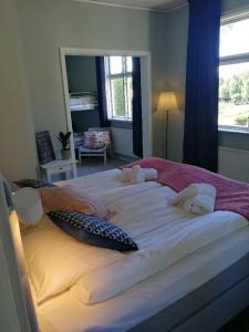 a large bed with white sheets and towels on it at Sjugare Gård Bed & Breakfast in Leksand