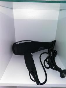 a black hair dryer sitting on top of a counter at Freatida apartment in Piraeus