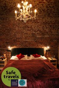 a bedroom with a large bed with a chandelier at Kino Hostel on Vyborgskaya in Saint Petersburg