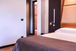 Postel nebo postele na pokoji v ubytování San Giorgio Palace Hotel Ragusa Ibla