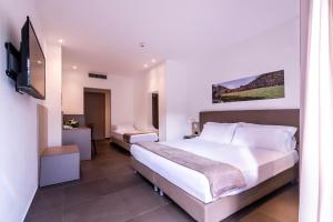 Postel nebo postele na pokoji v ubytování San Giorgio Palace Hotel Ragusa Ibla