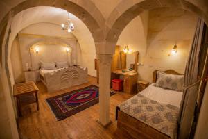 a large room with a bed and a table at Göreme Reva Hotel in Goreme +90 photos